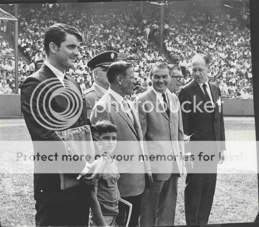 1968 Tony Conigliaro Boston Red Sox standing on field holding bag 